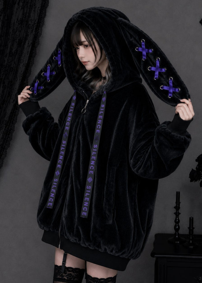 Resham Silence Bunny Ear Black Purple Faux Fur Oversized Jacket in black with purple lace-up bunny ear hood on jacket — side on model