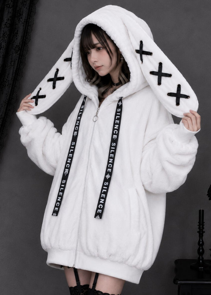 Resham Silence Bunny Ear White Black Faux Fur Oversized Jacket in white with black lace-up bunny ear hood on jacket — side on model