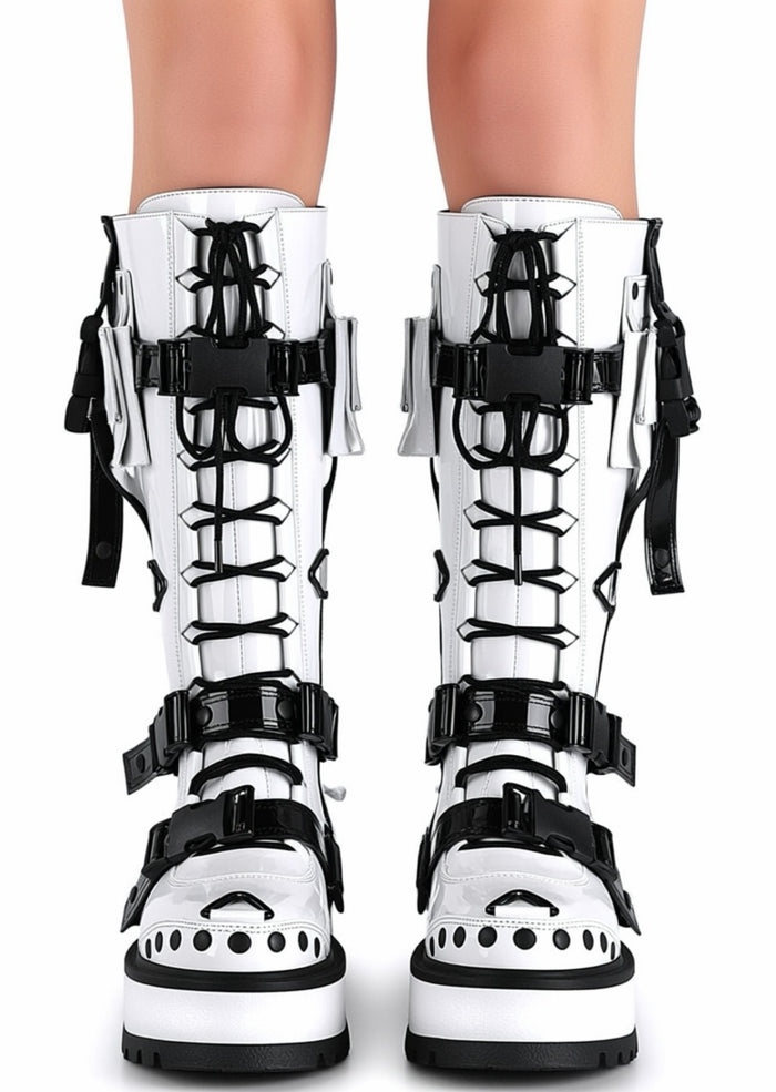 Demonia SLACKER 260 Cyberpunk Tech Patent White Rave Platform Boots in white vegan patent leather with contrast black tech straps worn by model — front view