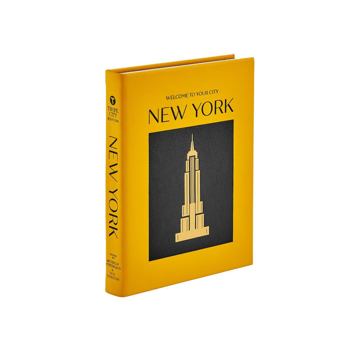 Yellow book with 'New York' and Empire State Building illustration on a white background