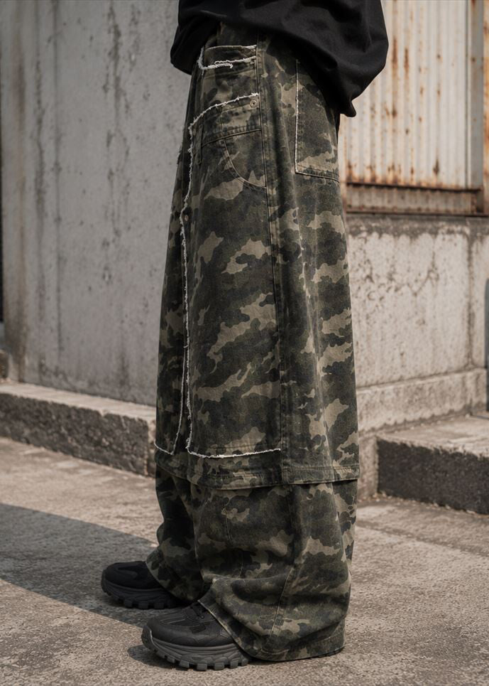 Suggestion Wasteland Camo Patchwork Baggy Pants in camo print with raw-edge patchwork panel on baggy pants — side on model