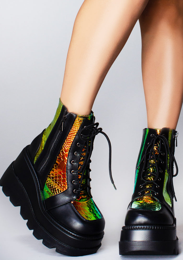 Front view of the black and yellow RADIO platform boots on-model, showcasing the heavy-duty black laces, metallic eyelets, and chunky combat-style platform toe.